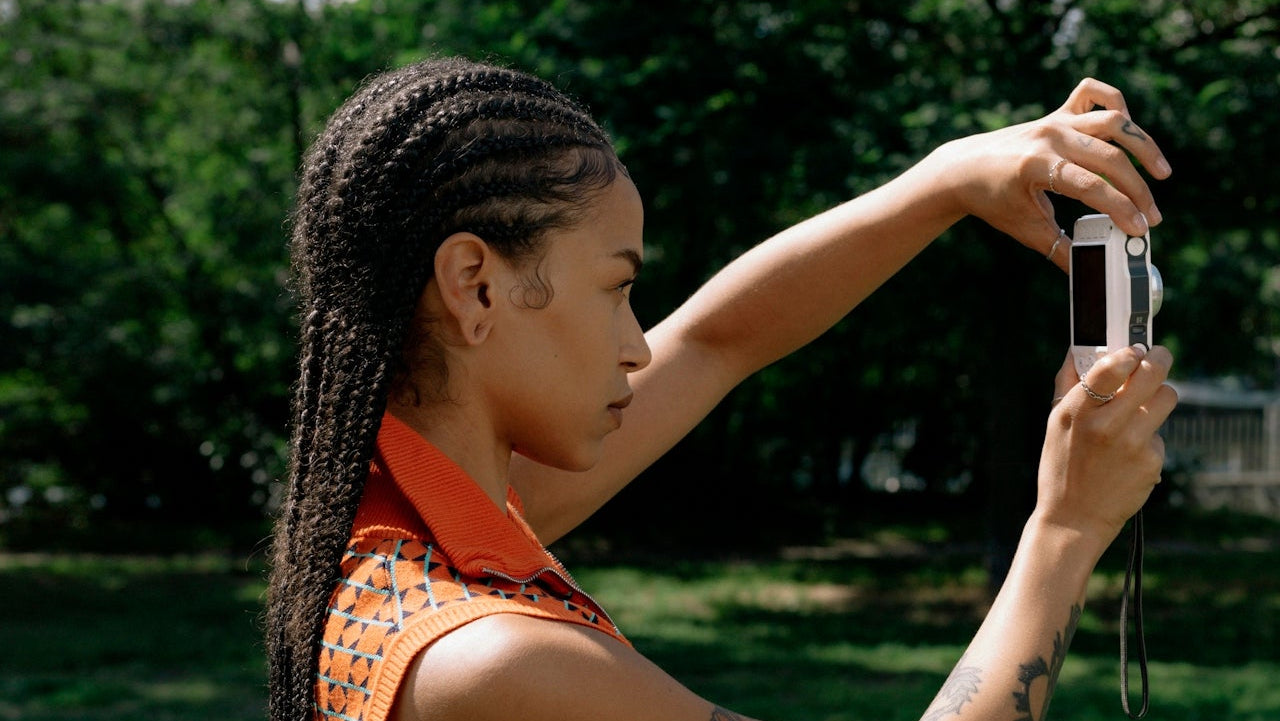 Woman taking a selfie outdoors with trees in the background