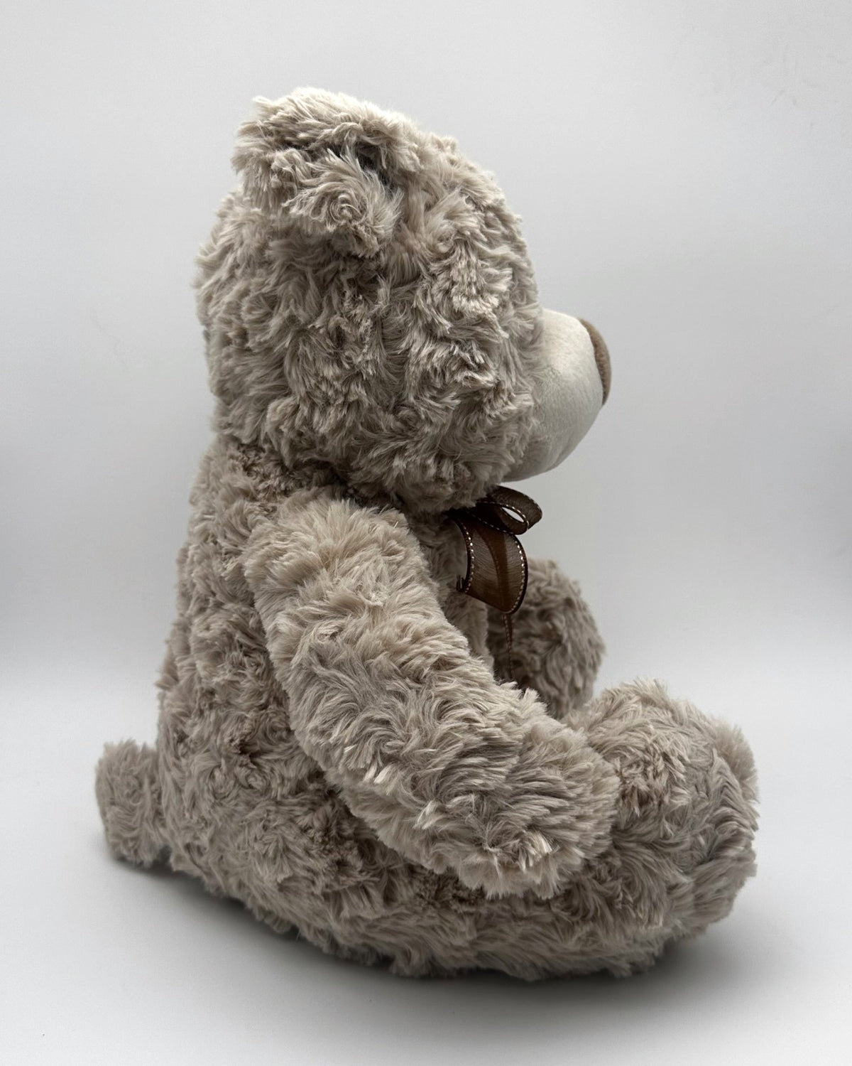 Grey Curly Teddy Bear · brown ribbon