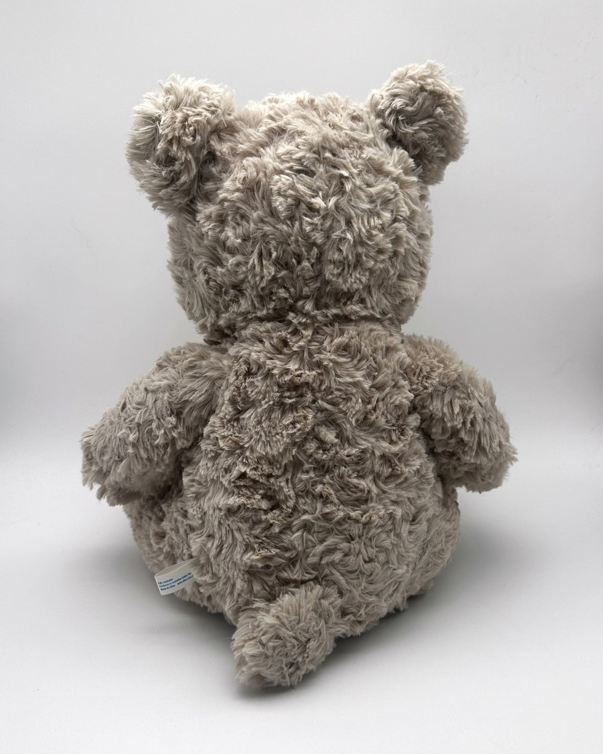Grey Curly Teddy Bear · brown ribbon